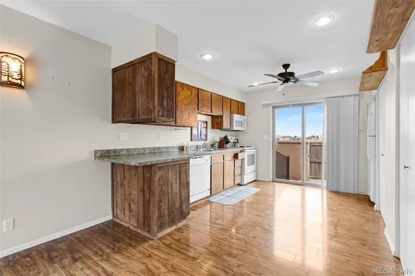 a kitchen with stainless steel appliances granite countertop a sink and wooden cabinets