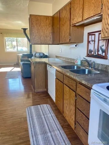 a kitchen with stainless steel appliances granite countertop a sink stove and cabinets