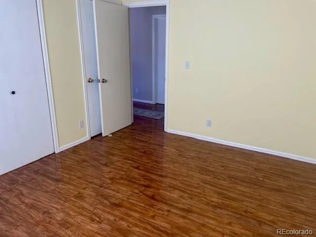 a view of a room with wooden floor