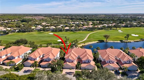 an aerial view of a houses with outdoor space and river