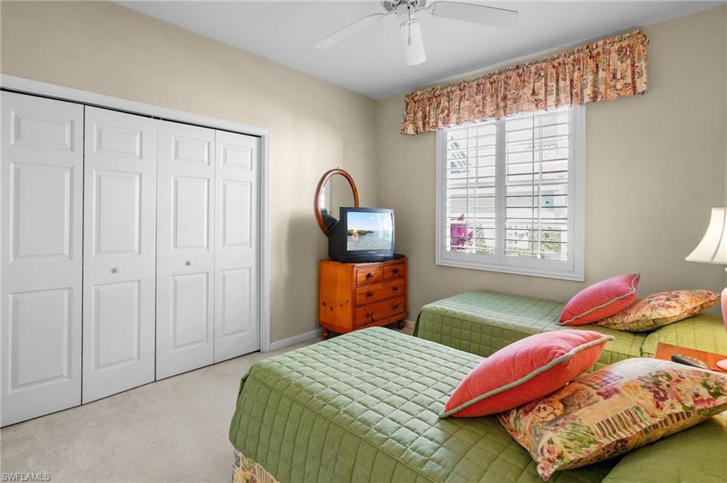 23081 Rosedale Drive, Unit 101 Estero, FL 34135 - Photo 13 of 38 a bedroom with two beds and a window