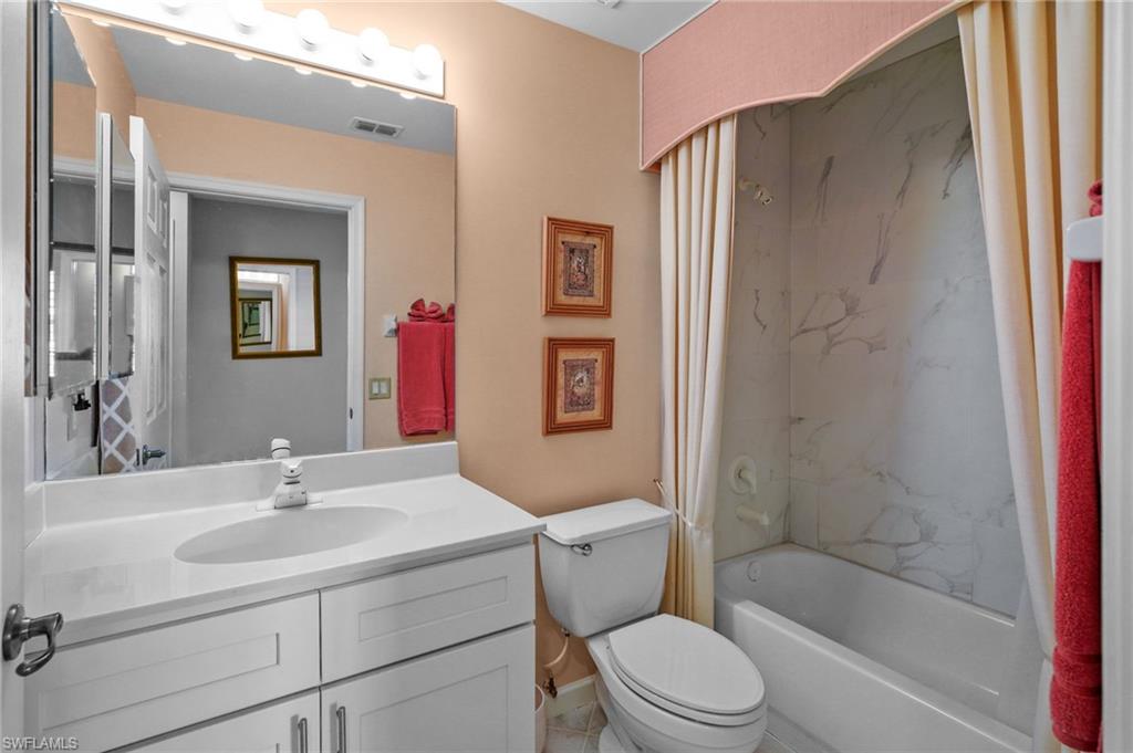 23081 Rosedale Drive, Unit 101 Estero, FL 34135 - Photo 14 of 38 Full bathroom featuring shower / bathtub combination with curtain and vanity