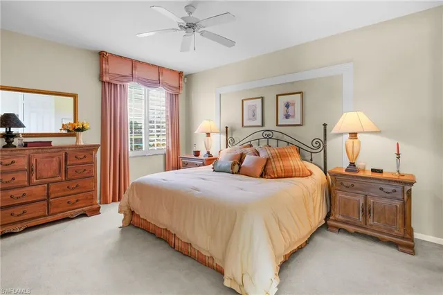 a bedroom with a bed and dresser with mirror