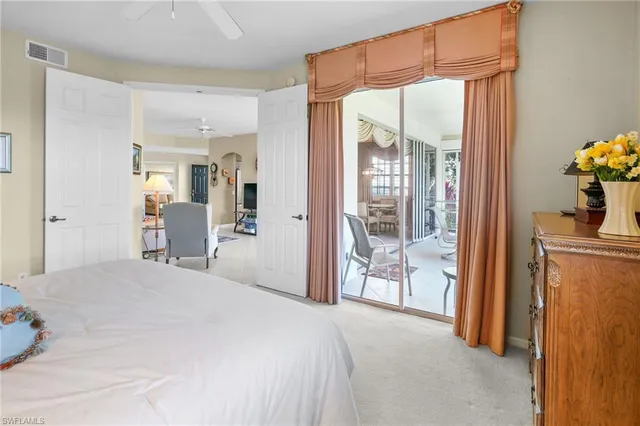 a bedroom with a bed and a large mirror