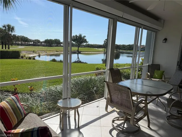 a view of a porch with furniture and a yard
