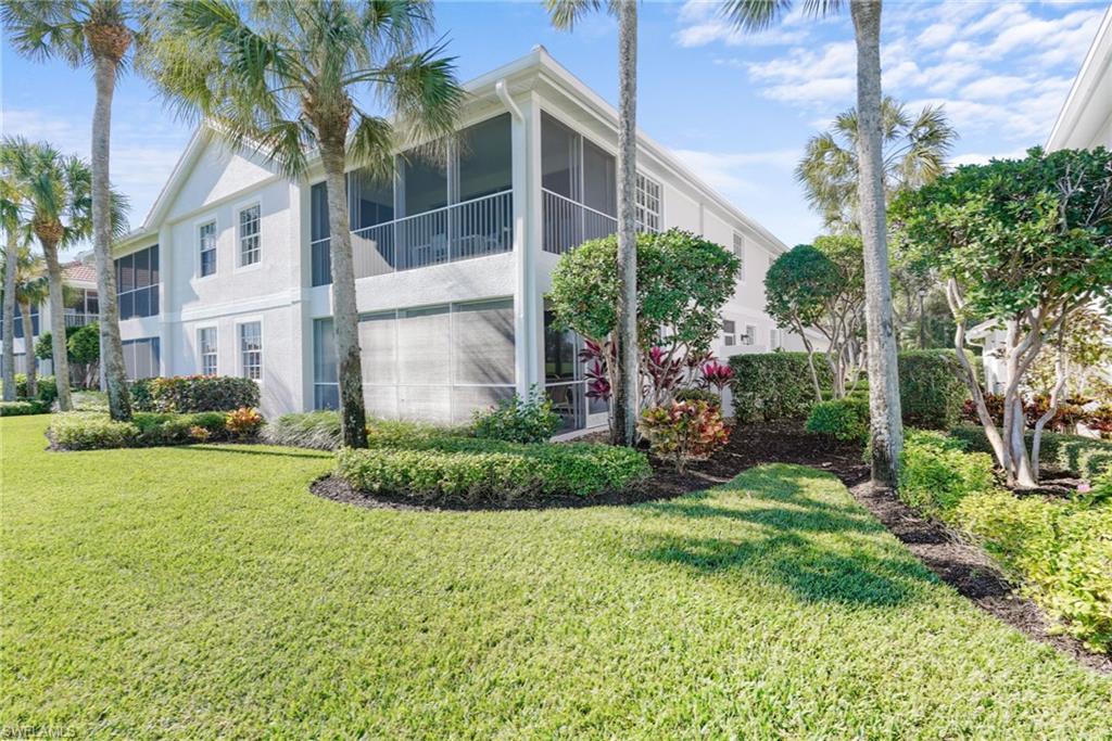 23081 Rosedale Drive, Unit 101 Estero, FL 34135 - Photo 29 of 38 a view of a garden in front of a building