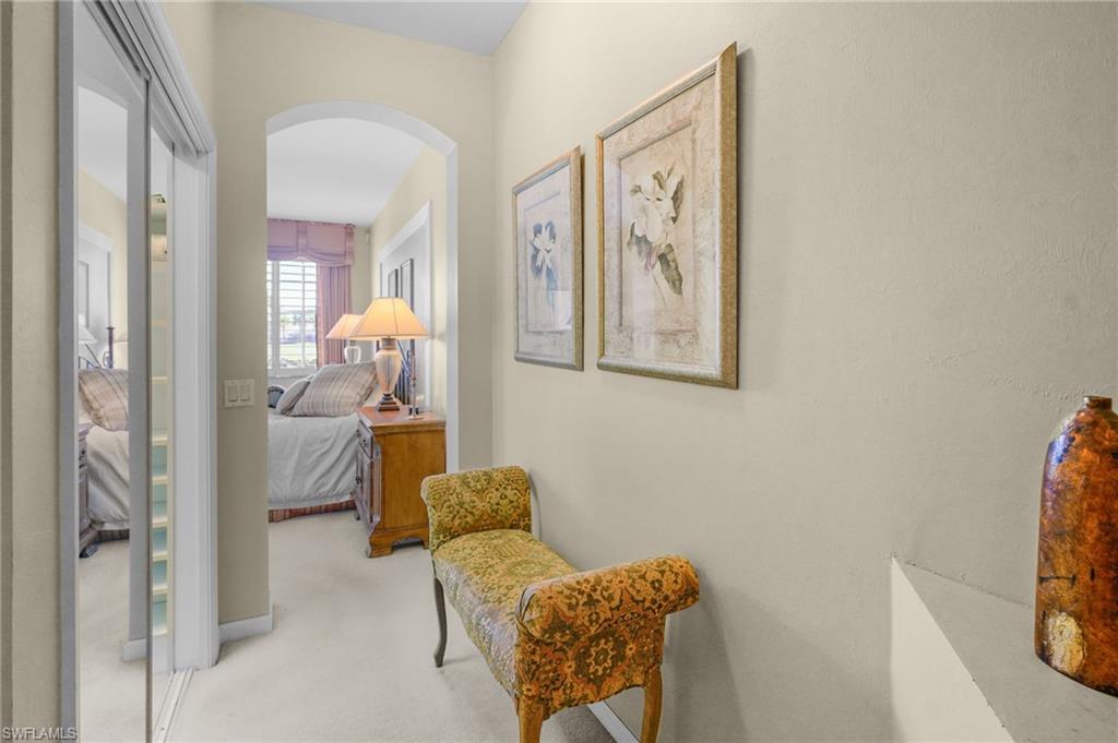 23081 Rosedale Drive, Unit 101 Estero, FL 34135 - Photo 31 of 41 Hallway featuring arched walkways and light carpet