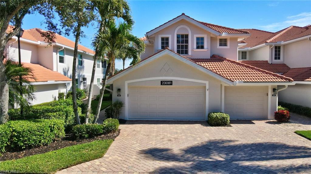 23081 Rosedale Drive, Unit 101 Estero, FL 34135 - Photo 4 of 41 Mediterranean / spanish house with stucco siding, a tiled roof, a garage, and decorative driveway