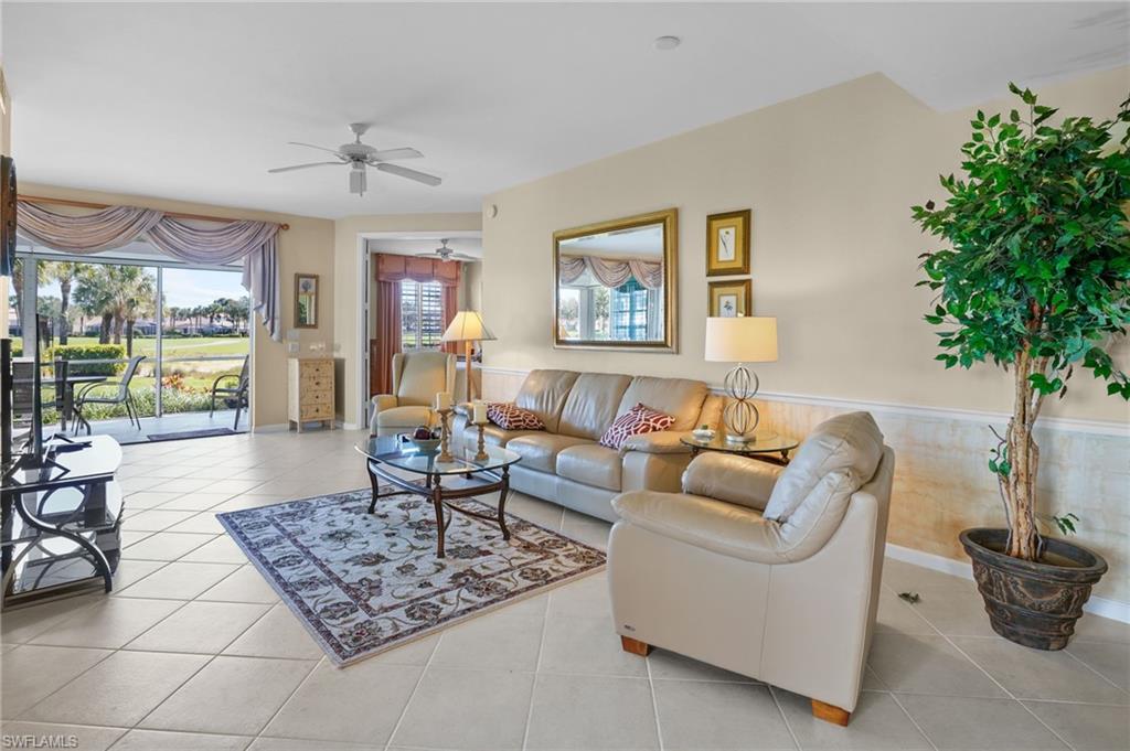 23081 Rosedale Drive, Unit 101 Estero, FL 34135 - Photo 10 of 41 Living room featuring a ceiling fan, healthy amount of natural light, and tile patterned floors