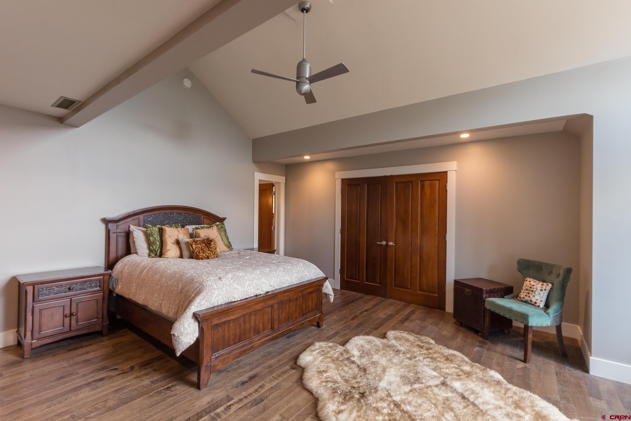 9475 High Meadows Durango, CO 81301 - Photo 19 of 35 a bedroom with a bed and a chair