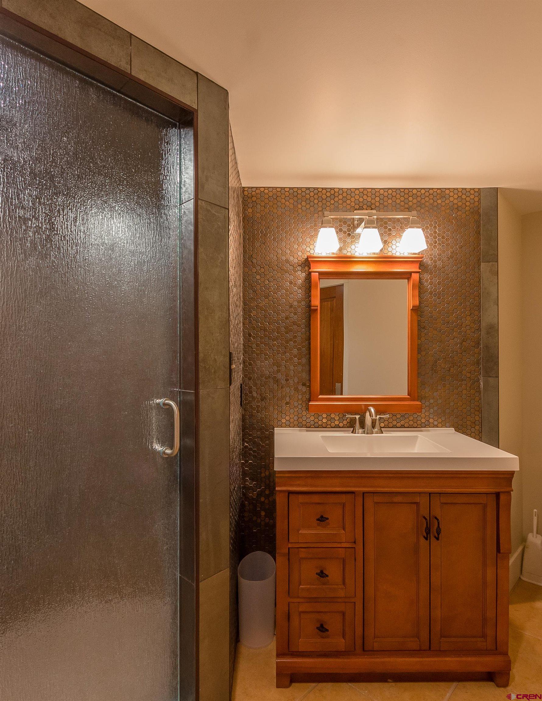 9475 High Meadows Durango, CO 81301 - Photo 23 of 35 a bathroom with a sink and a mirror