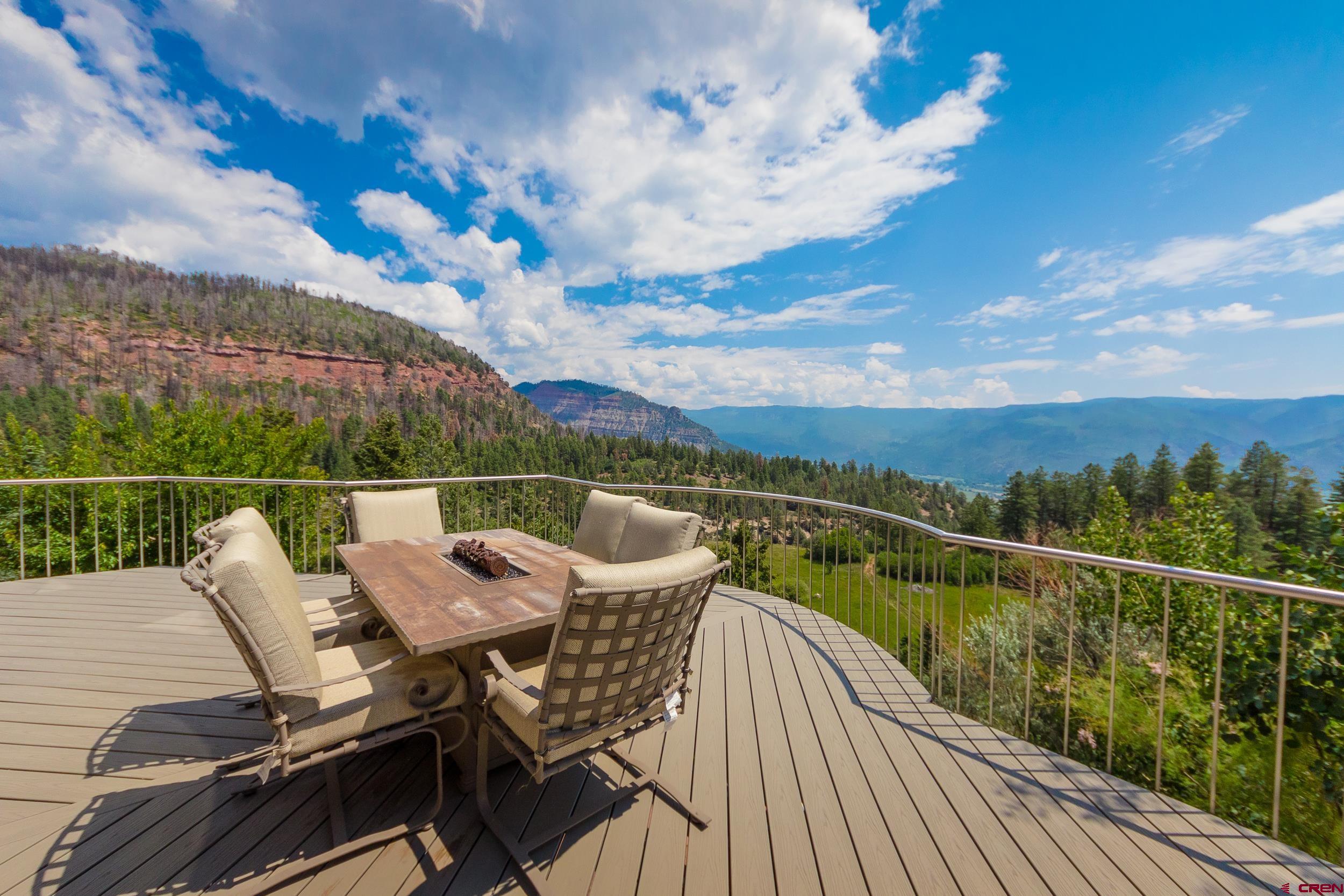 9475 High Meadows Durango, CO 81301 - Photo 4 of 35 a view of a balcony with two chairs and a table