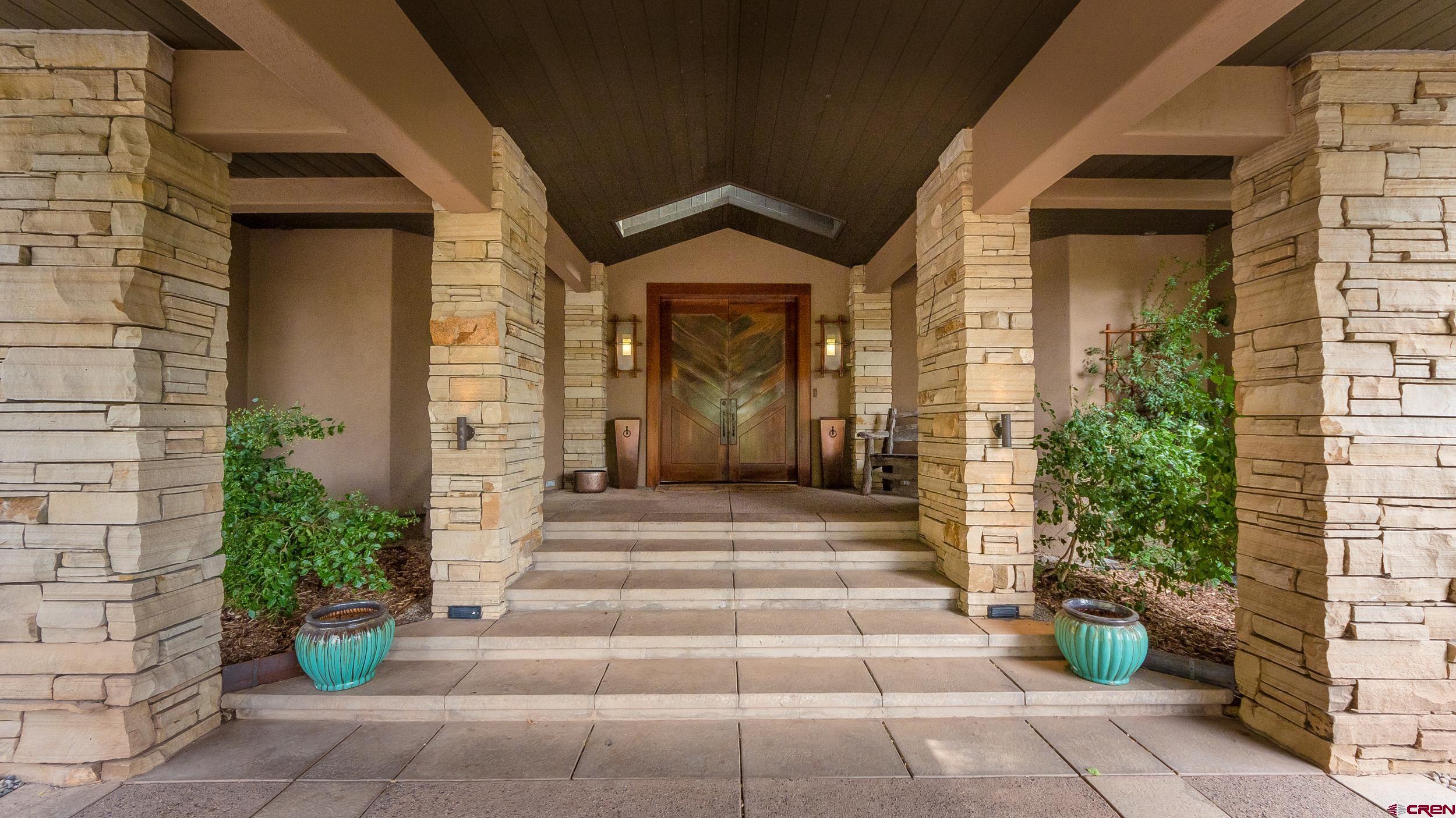 9475 High Meadows Durango, CO 81301 - Photo 5 of 35 a front view of a house with potted plants