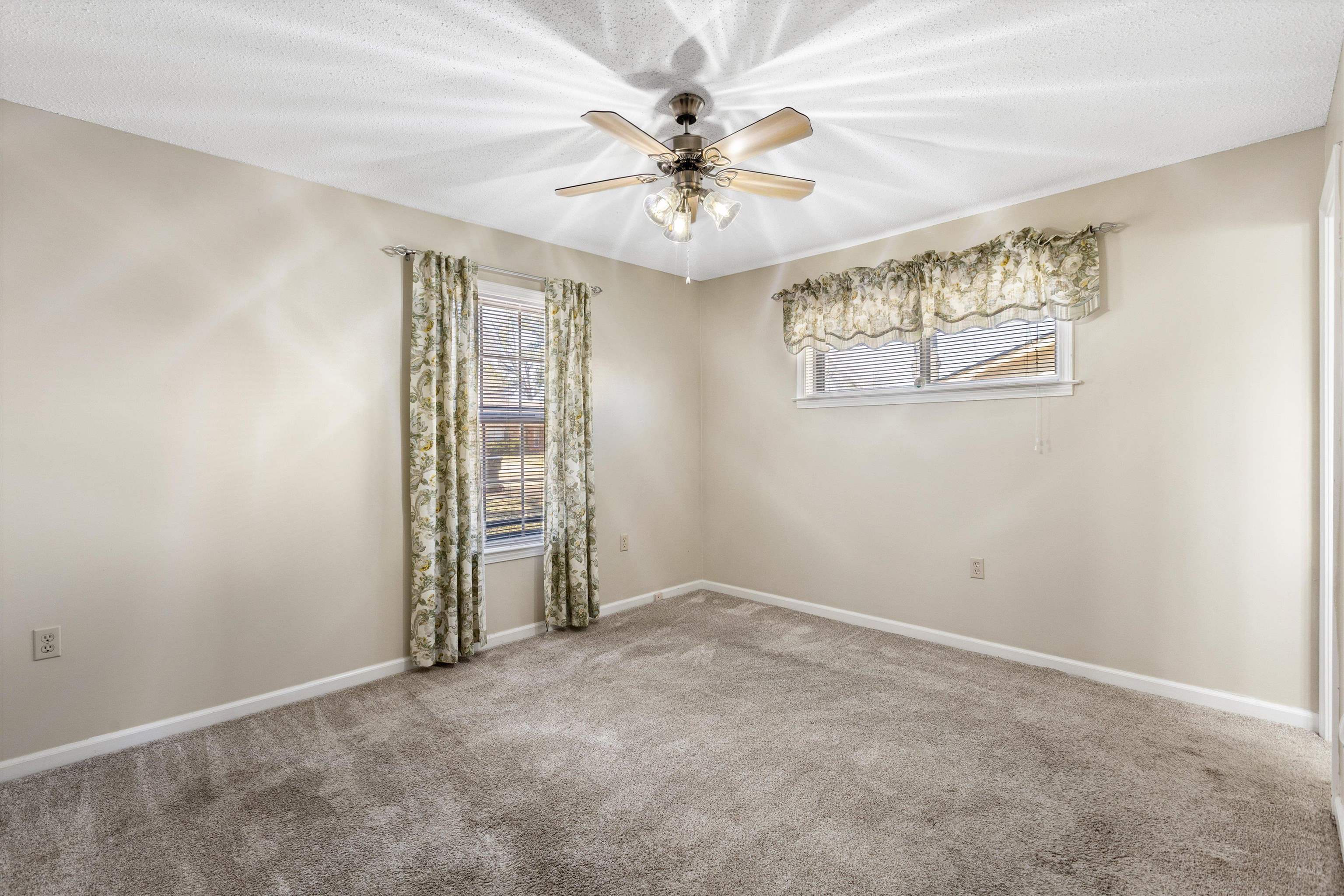 3876 Luther Road Bartlett, TN 38135 - Photo 15 of 20 Spare room featuring a ceiling fan, light carpet, and healthy amount of natural light