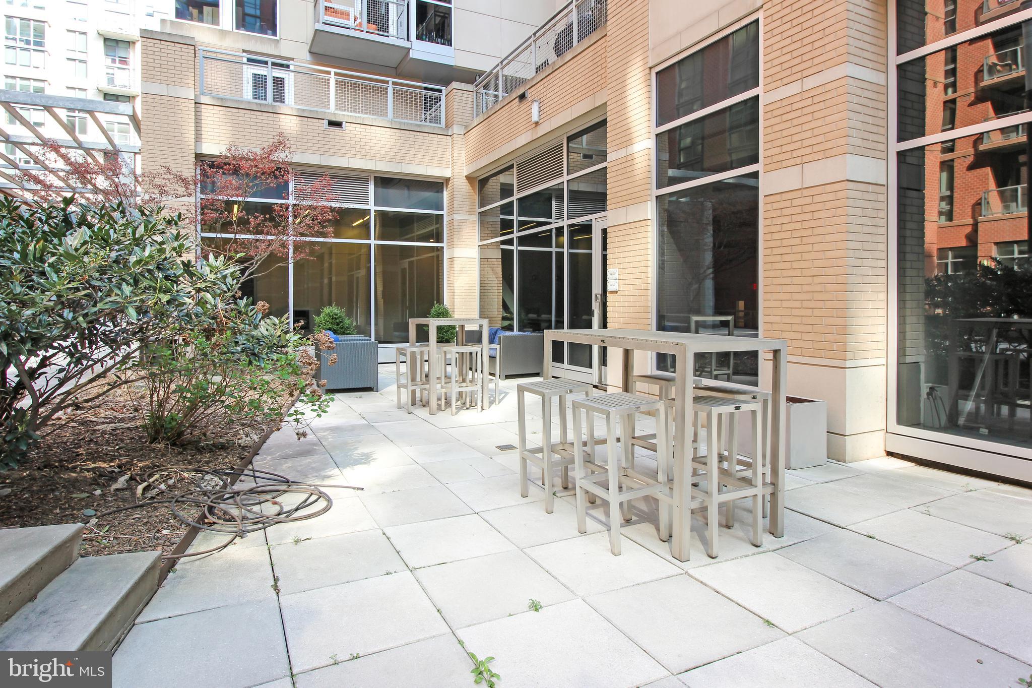 1025 First Street Southeast, Unit 612 Washington, DC 20003 - Photo 27 of 41 a building with table and chairs and potted plants