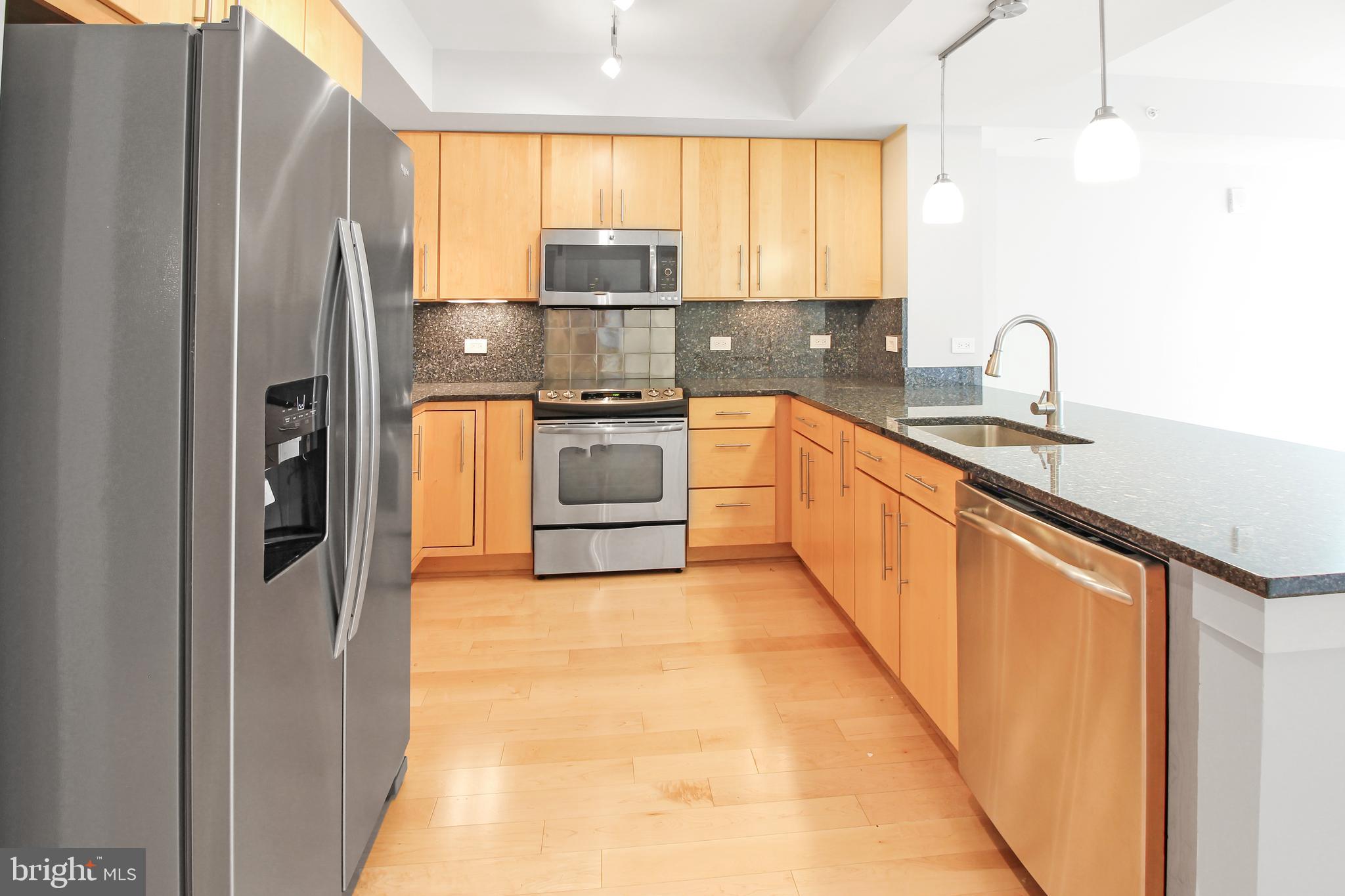 1025 First Street Southeast, Unit 612 Washington, DC 20003 - Photo 5 of 41 a kitchen with stainless steel appliances a refrigerator sink and cabinets