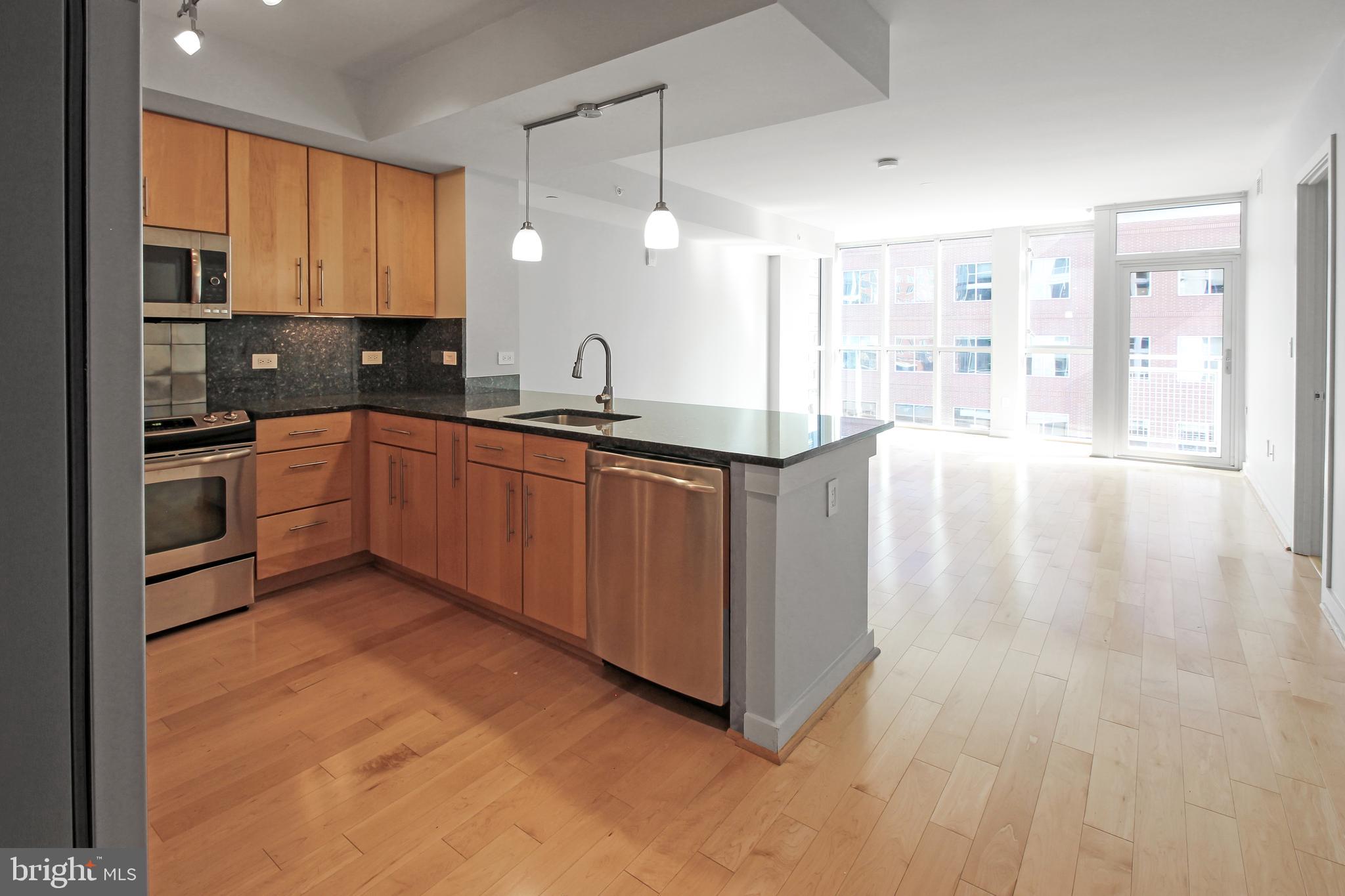 1025 First Street Southeast, Unit 612 Washington, DC 20003 - Photo 7 of 41 a kitchen with stainless steel appliances granite countertop a stove a sink dishwasher and a refrigerator