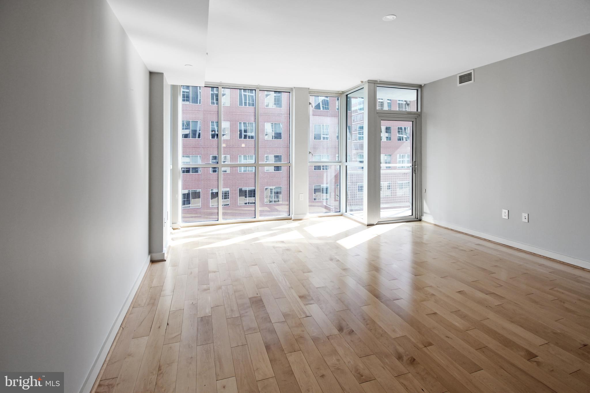 1025 First Street Southeast, Unit 612 Washington, DC 20003 - Photo 9 of 41 wooden floor in an empty room with a window