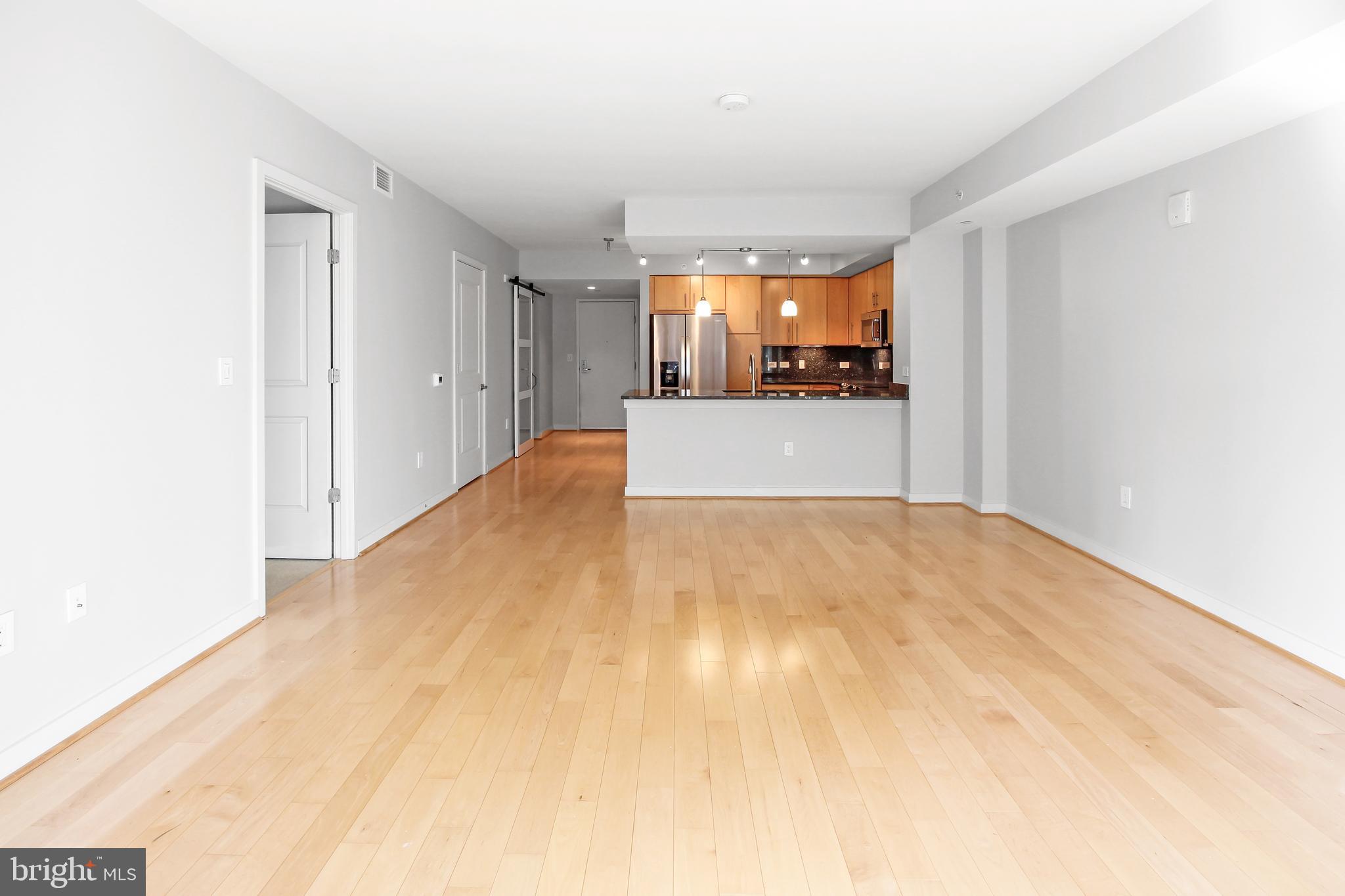 1025 First Street Southeast, Unit 612 Washington, DC 20003 - Photo 10 of 41 a view of a big room with wooden floor and a window