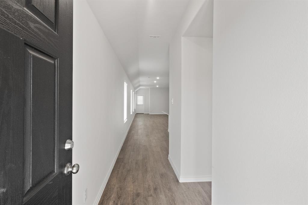 1604 Romans Road Ennis, TX 75119 - Photo 3 of 15 a view of a hallway with wooden floor