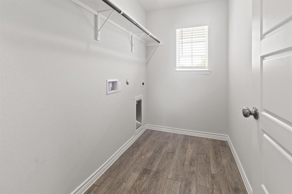 1604 Romans Road Ennis, TX 75119 - Photo 8 of 15 a view of a room with wooden floor and white walls