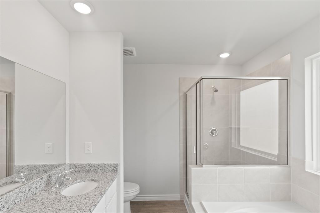 1604 Romans Road Ennis, TX 75119 - Photo 9 of 15 a bathroom with a granite countertop sink and shower