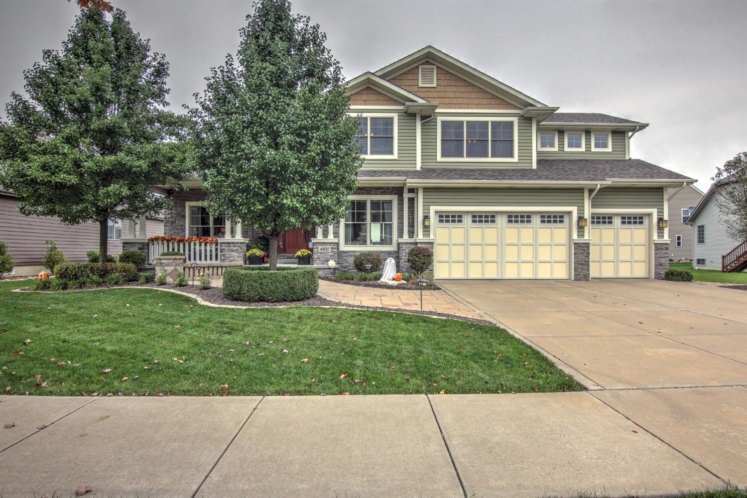 a front view of a house with a garden
