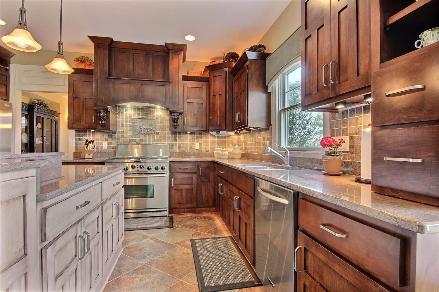 4930 West 100th Lane Crown Point, IN 46307 - Photo 6 of 10 a kitchen with stainless steel appliances granite countertop a sink stove and refrigerator