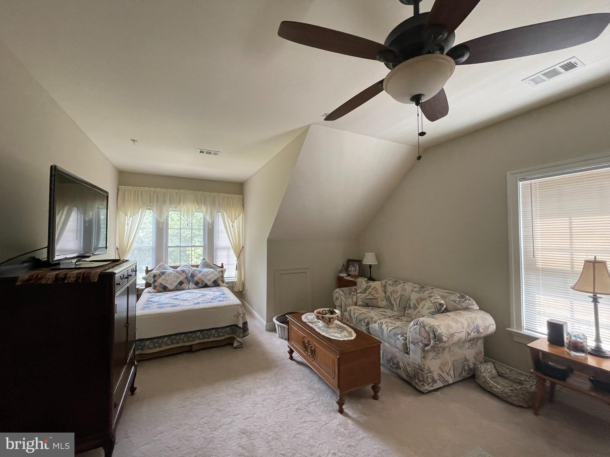1670 Monument Road Middletown, MD 21769 - Photo 50 of 69 a spacious bedroom with a bed and a chandelier