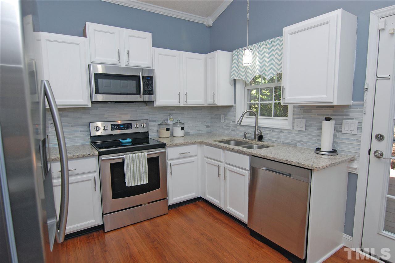 4501 Pinckney Place Raleigh, NC 27604 - Photo 13 of 22 a kitchen with white cabinets stainless steel appliances and sink