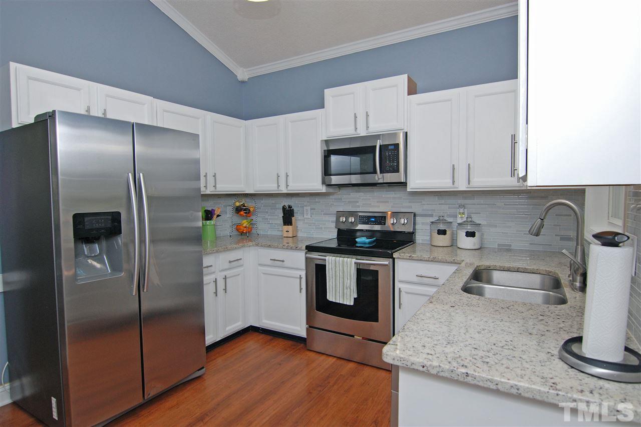 4501 Pinckney Place Raleigh, NC 27604 - Photo 14 of 22 a kitchen with granite countertop a refrigerator sink and microwave