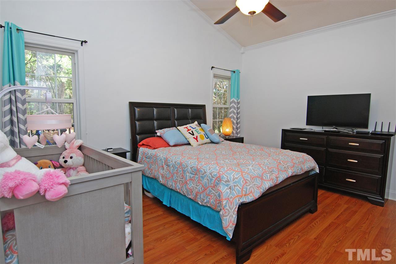 4501 Pinckney Place Raleigh, NC 27604 - Photo 15 of 22 a bedroom with a bed and flat screen tv