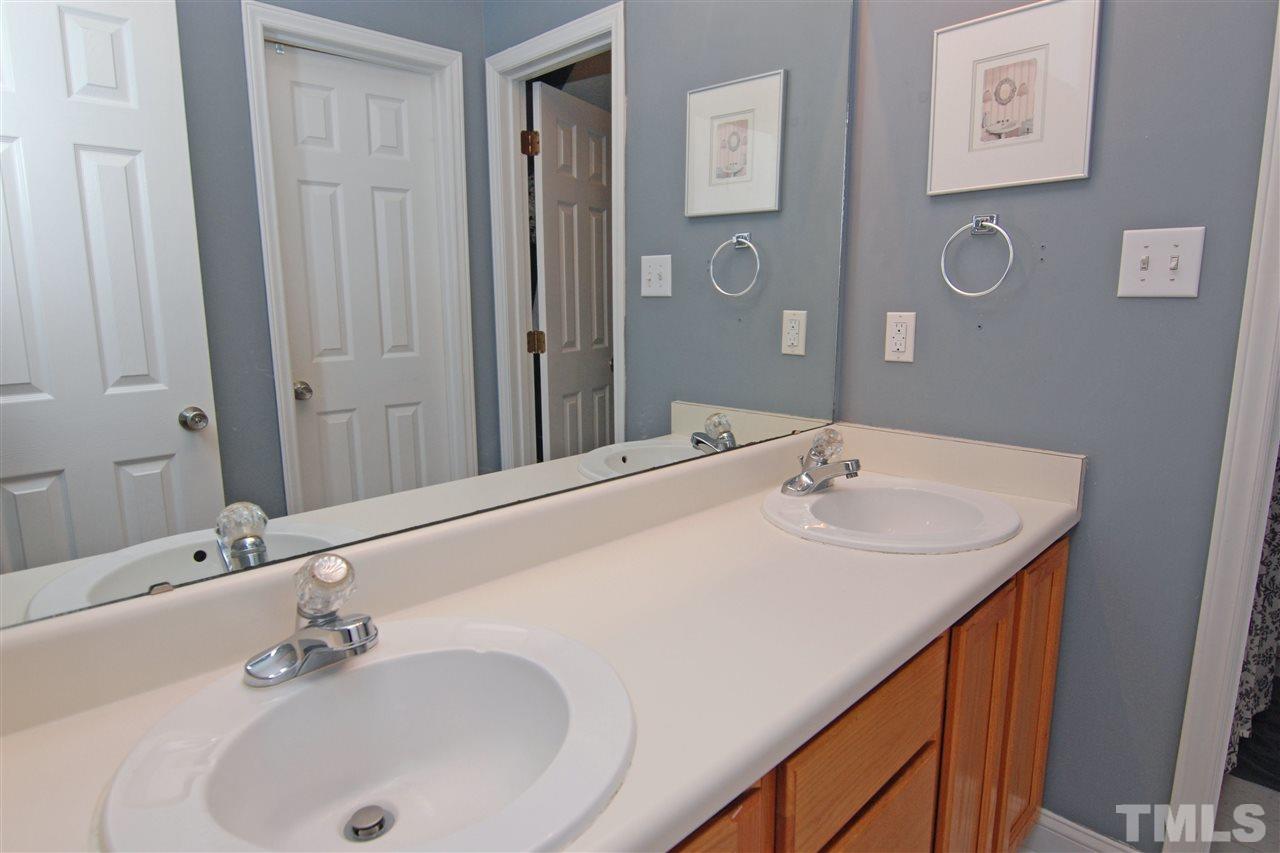 4501 Pinckney Place Raleigh, NC 27604 - Photo 16 of 22 a bathroom with a sink and a mirror