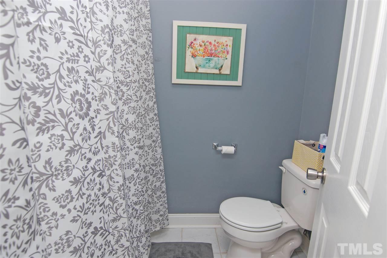 4501 Pinckney Place Raleigh, NC 27604 - Photo 17 of 22 a white toilet sitting next to a shower curtain