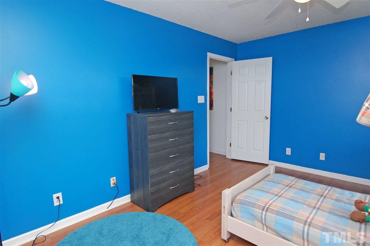 4501 Pinckney Place Raleigh, NC 27604 - Photo 19 of 22 a bedroom with a bed and a television