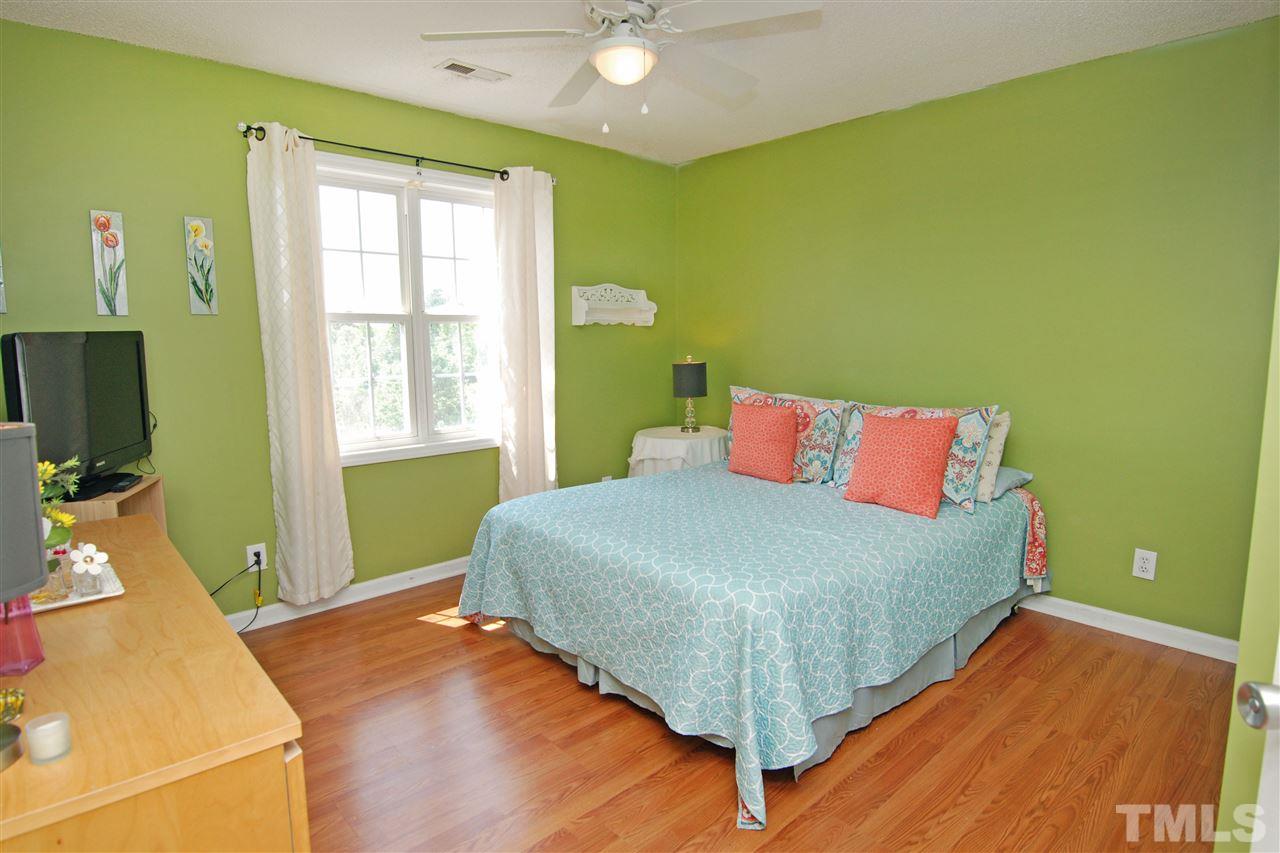 4501 Pinckney Place Raleigh, NC 27604 - Photo 20 of 22 a bed sitting in a bedroom next to a window