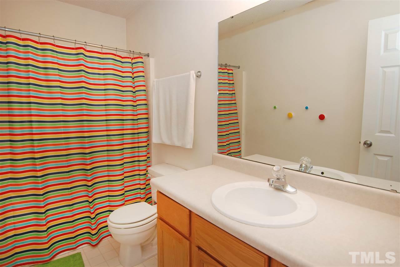 4501 Pinckney Place Raleigh, NC 27604 - Photo 22 of 22 a bathroom with a sink mirror vanity and toilet