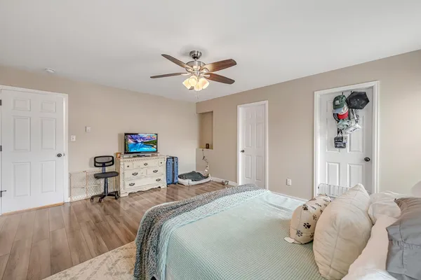 a bedroom with a bed and a chandelier