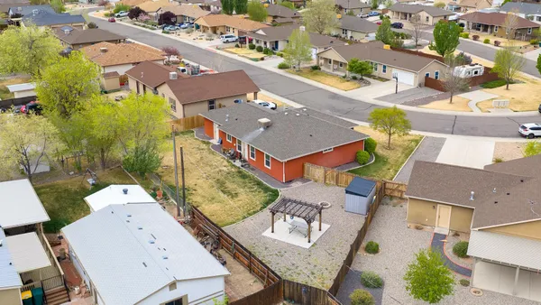 a view of an house with backyard space and balcony