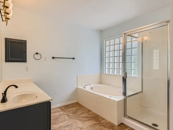 a bathroom with a bathtub and shower