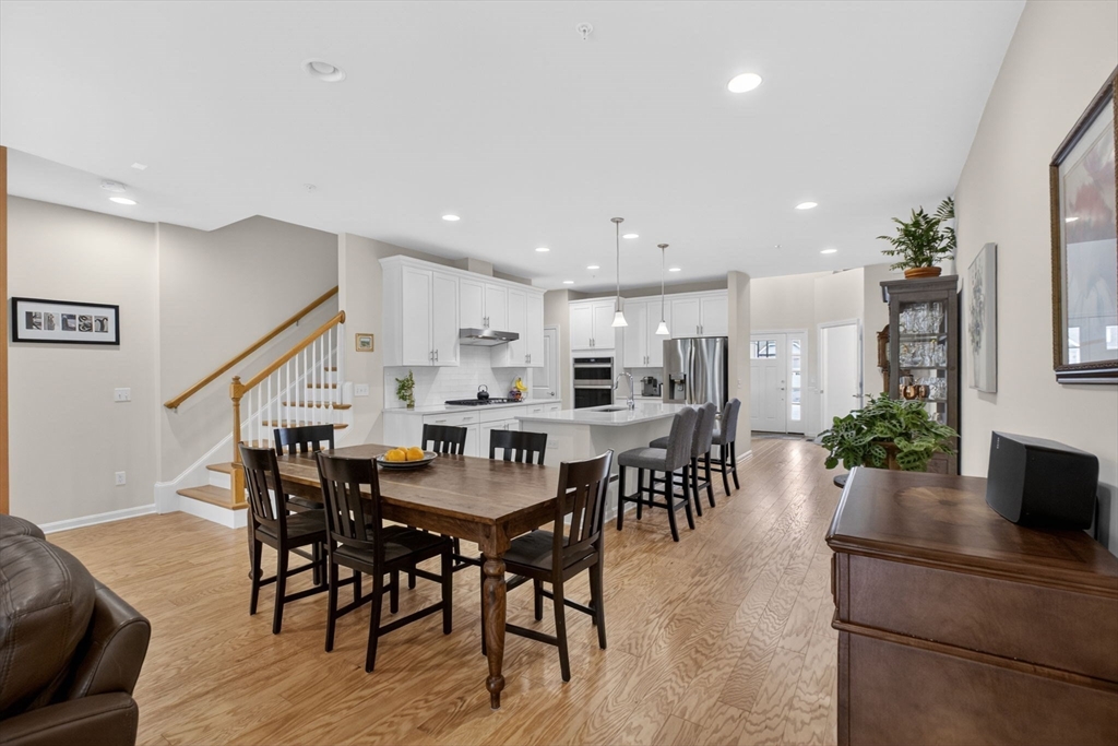87 Shannon Way, Unit 86 Upton, MA 01568 - Photo 8 of 36 a view of a dining room with furniture and wooden floor