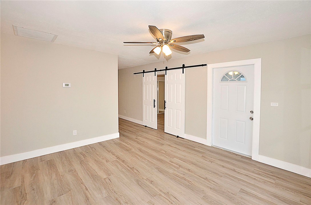 355 6th Road Southwest Vero Beach, FL 32962 - Photo 11 of 23 an empty room with wooden floor fan and windows