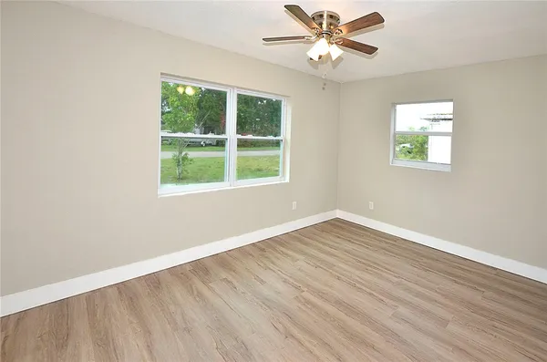wooden floor in an empty room with a window