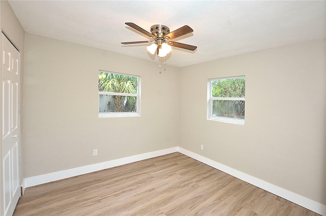 355 6th Road Southwest Vero Beach, FL 32962 - Photo 20 of 23 an empty room with wooden floor and windows