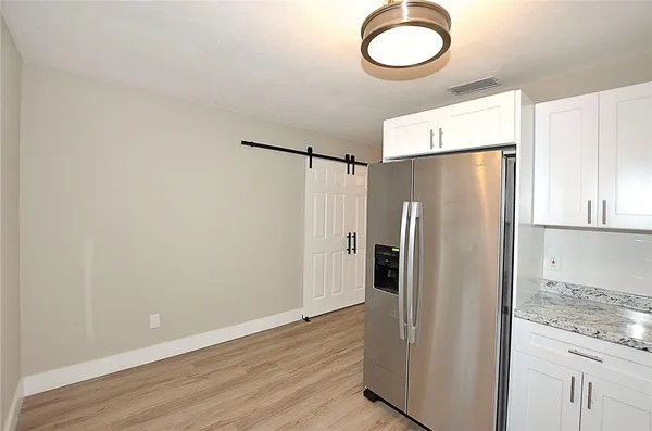 a kitchen with stainless steel appliances granite countertop a refrigerator and a stove