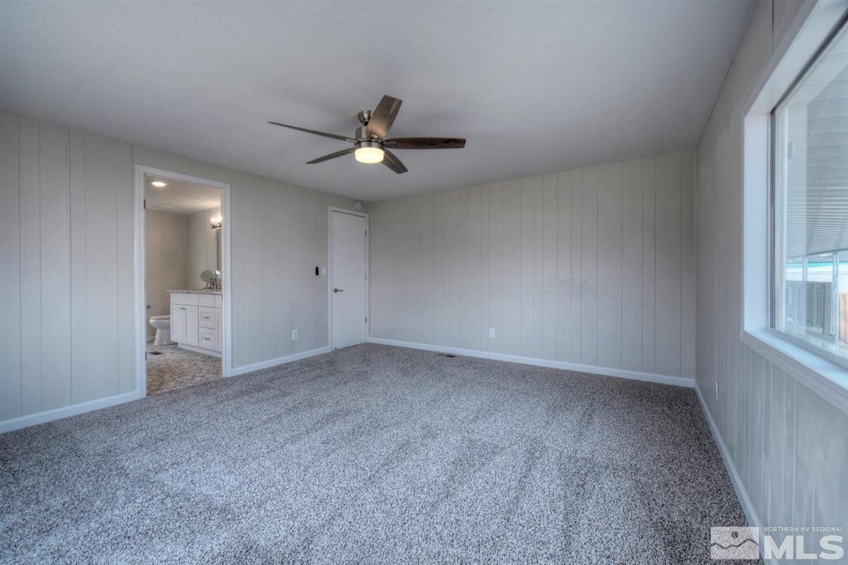 370 Scorpio Circle Reno, NV 89521 - Photo 12 of 25 an empty room with a empty space and a ceiling fan
