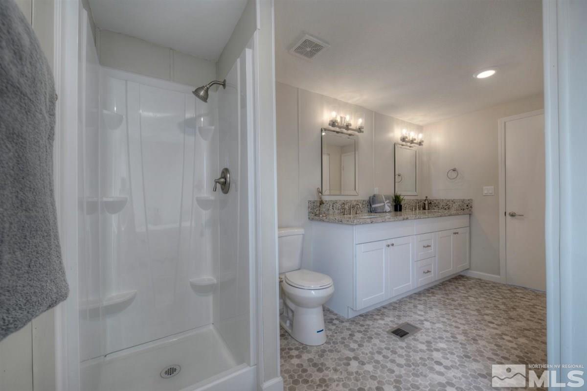 370 Scorpio Circle Reno, NV 89521 - Photo 15 of 25 a bathroom with a granite countertop sink a toilet and shower