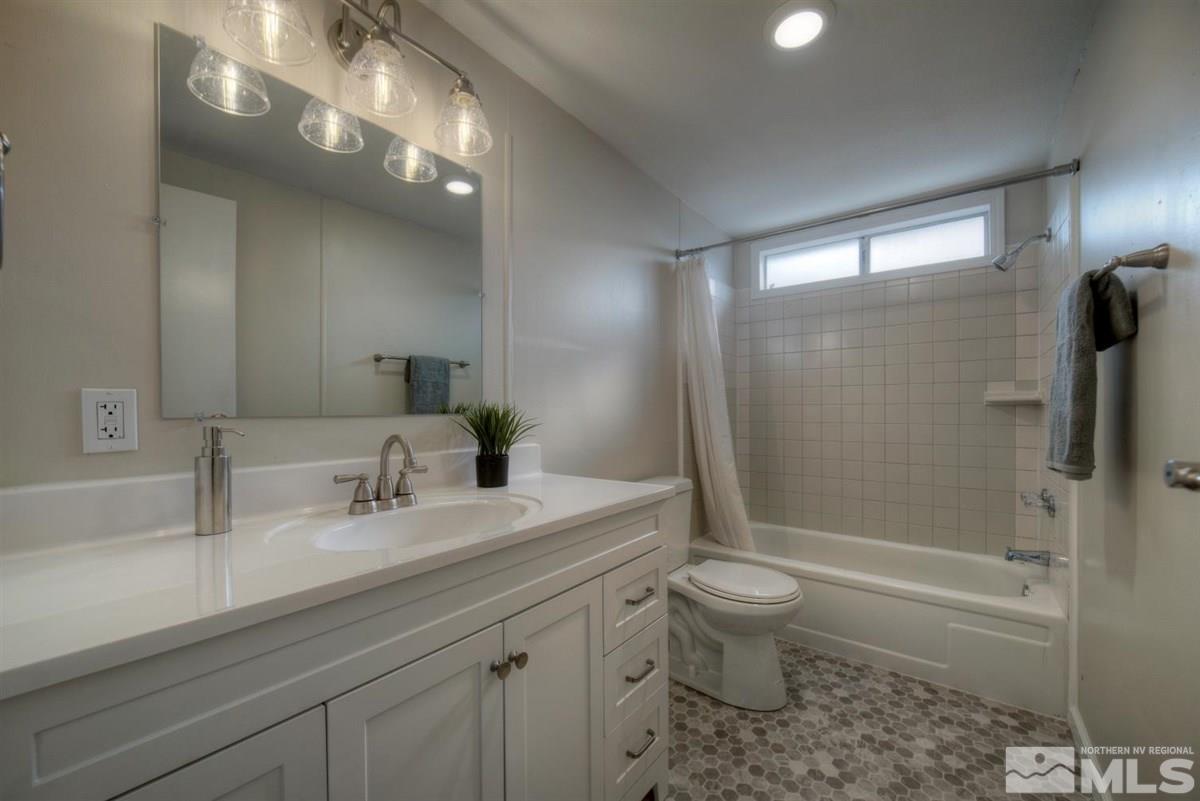 370 Scorpio Circle Reno, NV 89521 - Photo 18 of 25 a bathroom with a sink a toilet a mirror and shower