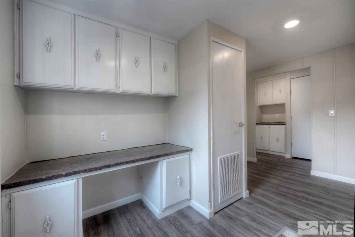 370 Scorpio Circle Reno, NV 89521 - Photo 19 of 25 a kitchen with a white cabinets and wooden floor