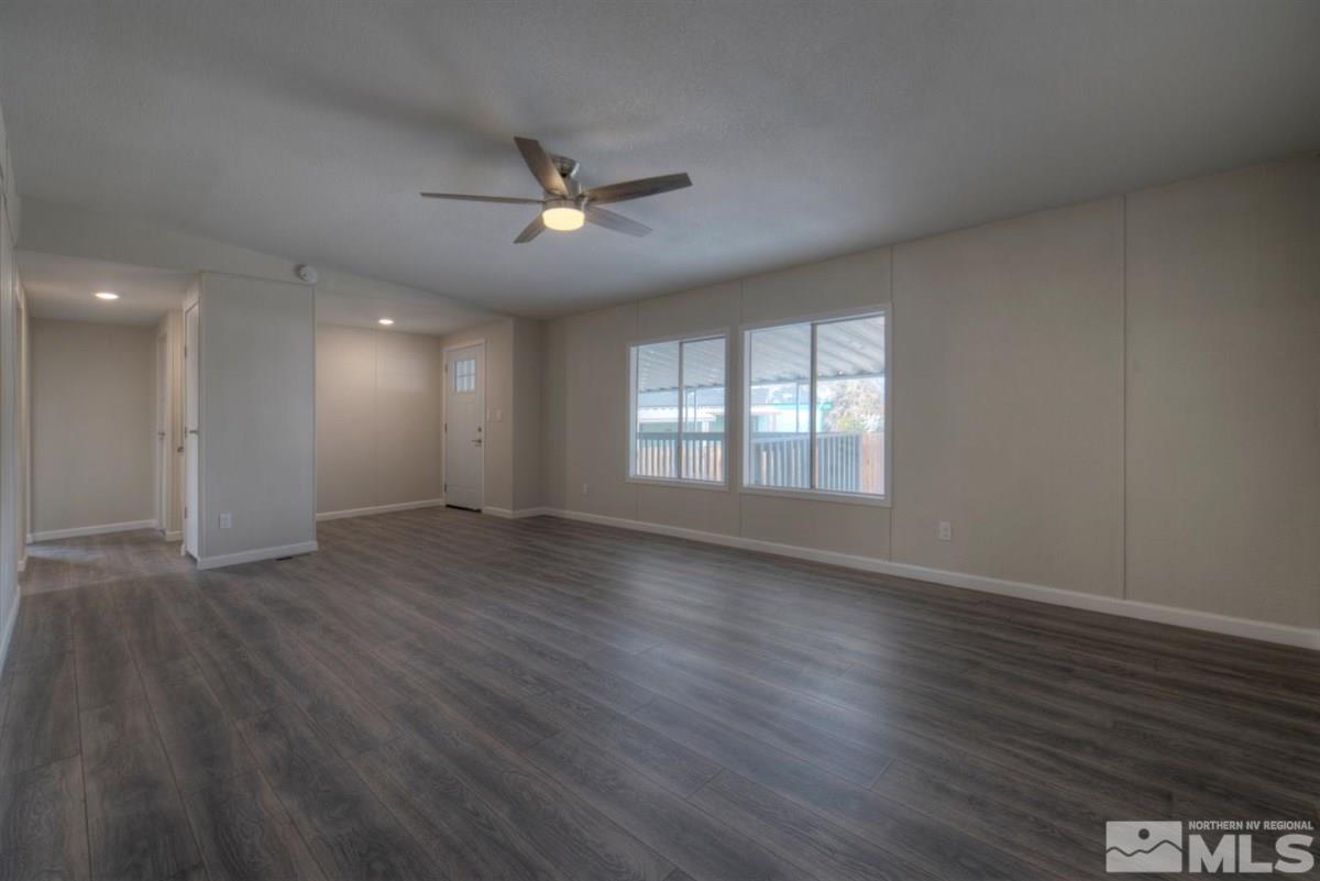 370 Scorpio Circle Reno, NV 89521 - Photo 2 of 25 a view of an empty room with wooden floor and a window